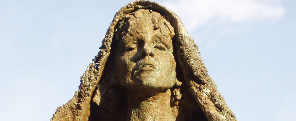 A bronze statue of St. Hildegard von Bingen.